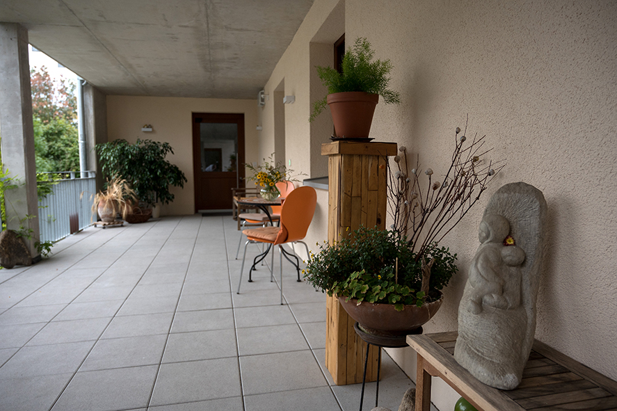 Ein Laubengang mit Deko und Sitzmöbeln.